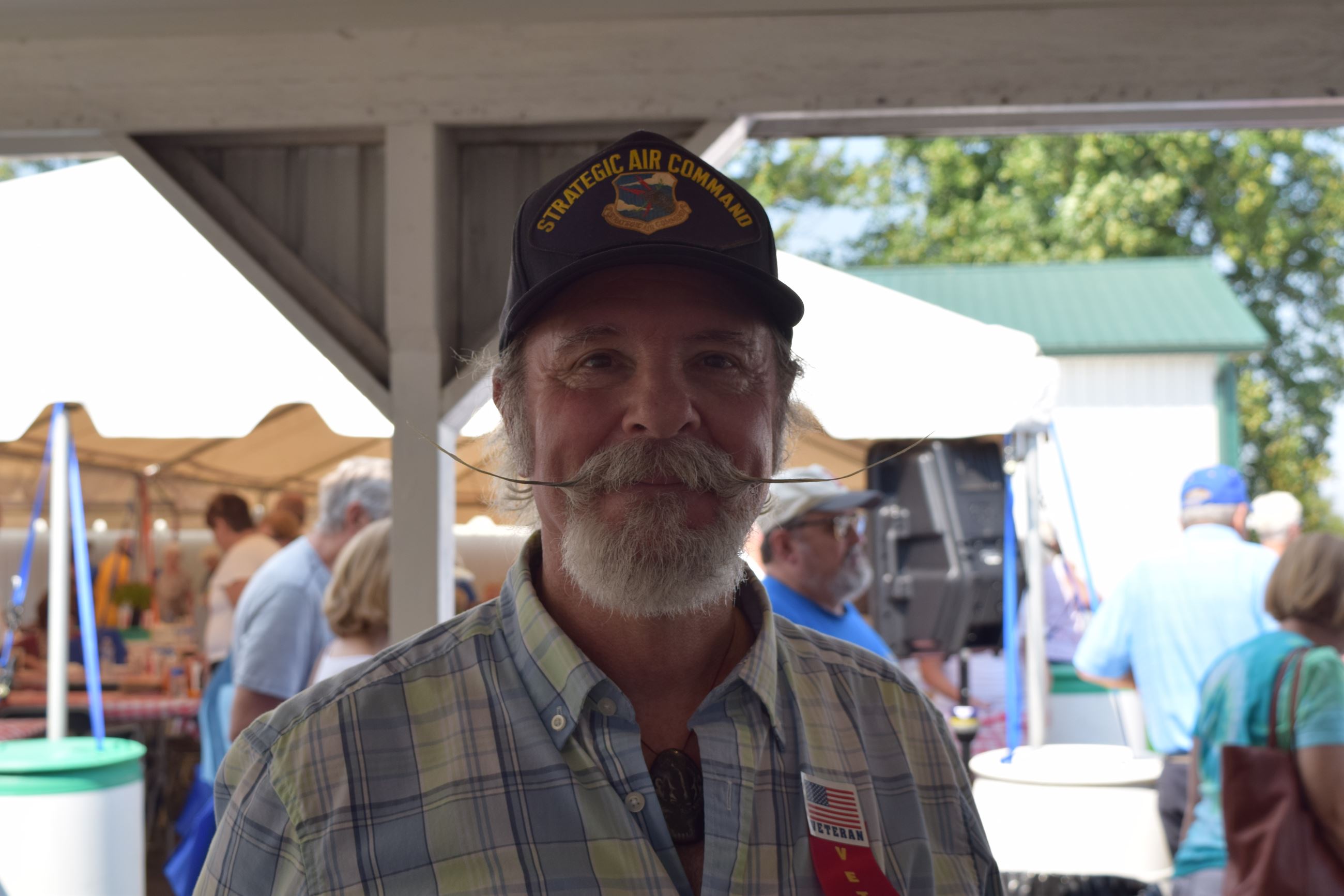 Man with a large mustache wearing "Strategic Air Command" cap