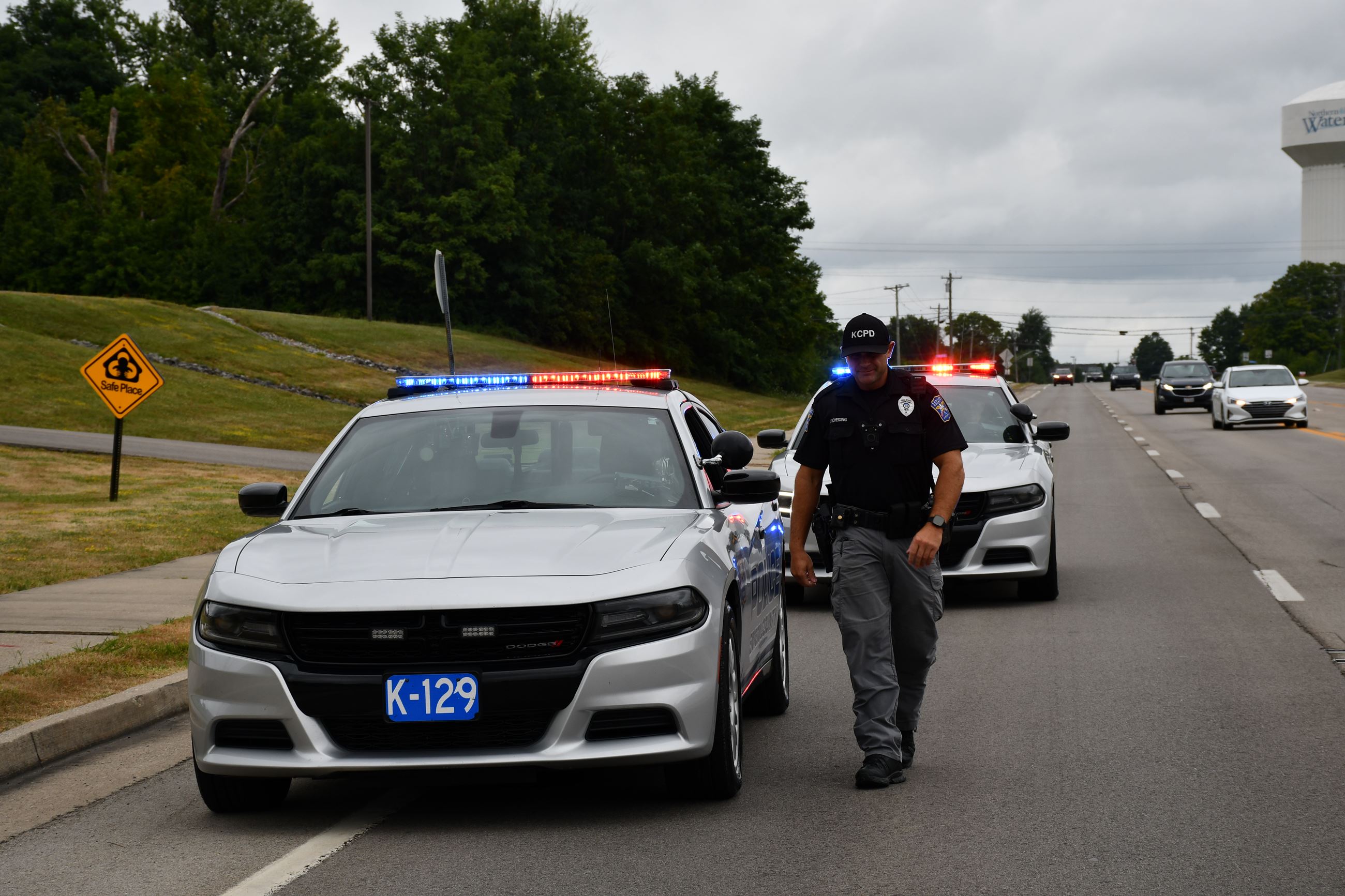 KCPD officer walking by squad car on US17