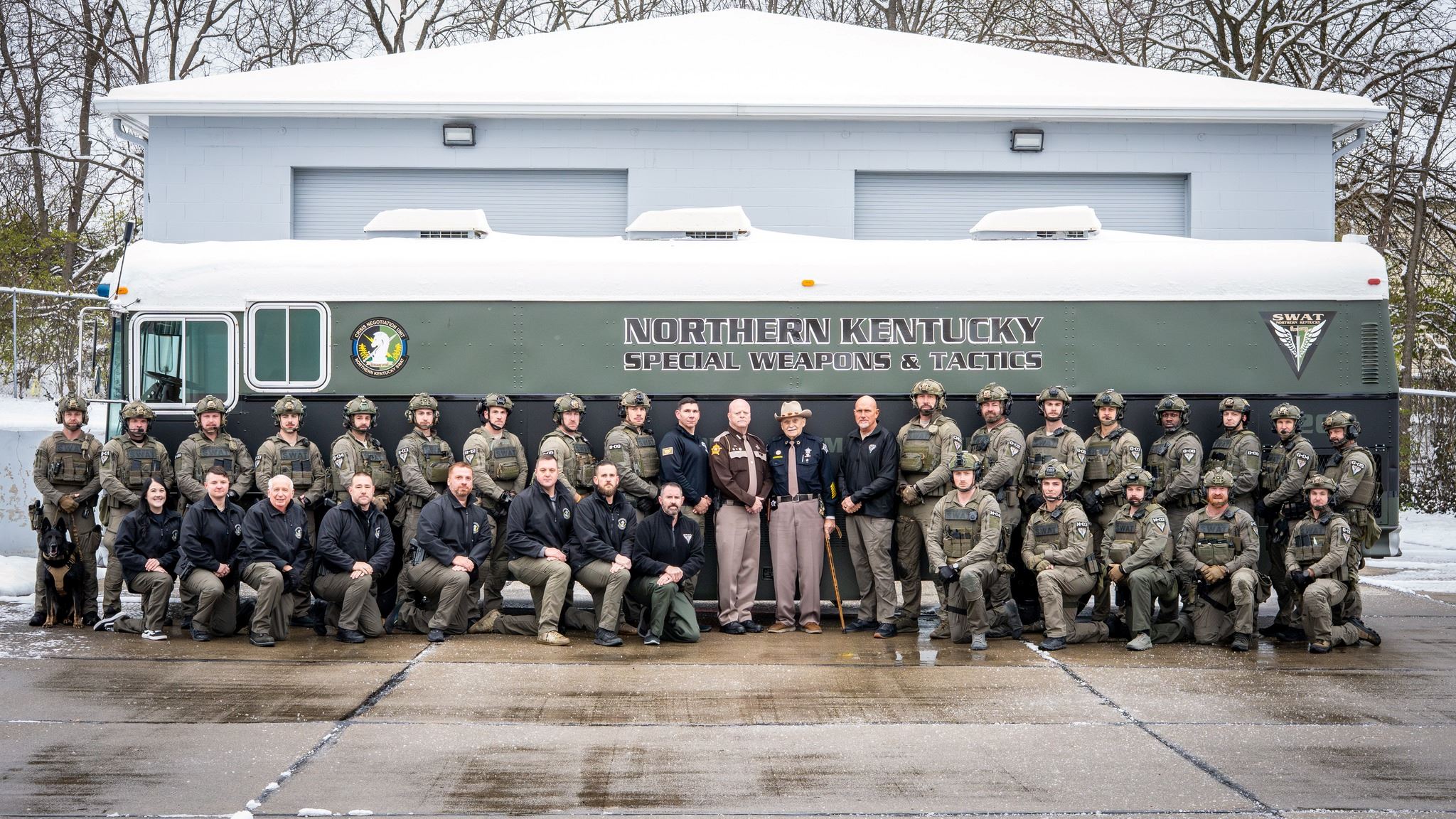 Members of Northern Kentucky SWAT poses together in front of vehicle